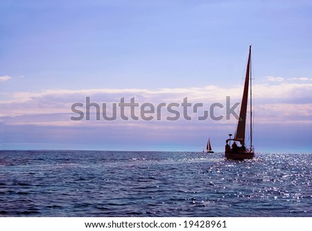 Sailboat on the ocean as the sun sets
