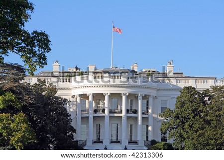 Closeup of the home of the United States President, the White House, South lawn.  Secret Service Agent on roof.