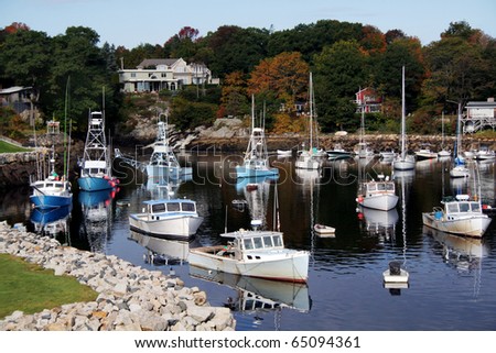 Fishing boats are docked in Perkins Cove, Maine in Autumn.