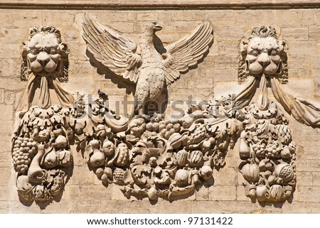 The bas-relief on the wall on one of the buildings opposite the pope\'s palace in Avignon, France.