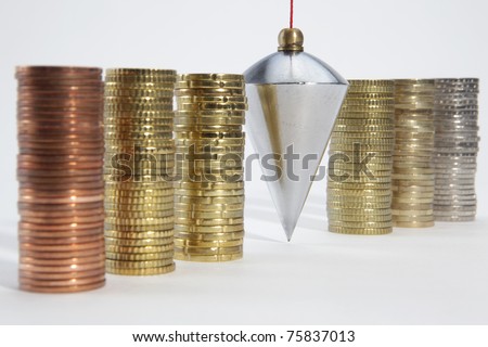 Plumb bob with coin stacks on white background