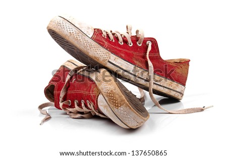 a pair of dirty sneakers isolated on white