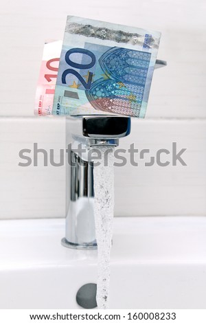 euro money on the tap and flowing water
