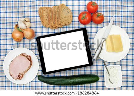 breakfast table with blank digital tablet in the center