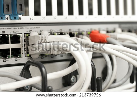 network hub and cables connected to servers in a datacenter