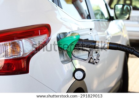 refilling the car with fuel in gas station