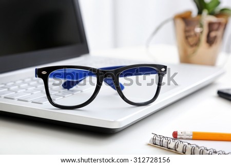workspace with hipster glasses on laptop