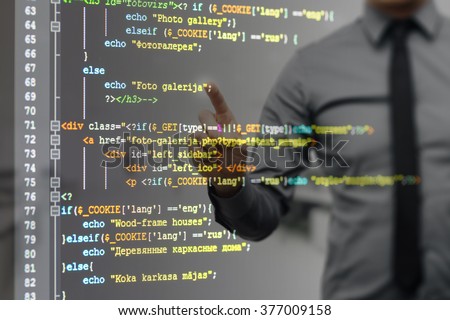 man pointing on virtual screen with website programming code (There is no potentially infringes on intellectual property rights)