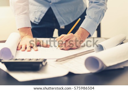 architect, engineer working on construction project at office