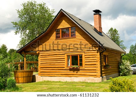 Wooden house for rest with a sauna and the big wooden font