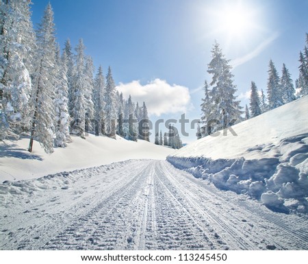 Empty Snow Covered Road In Winter Landscape