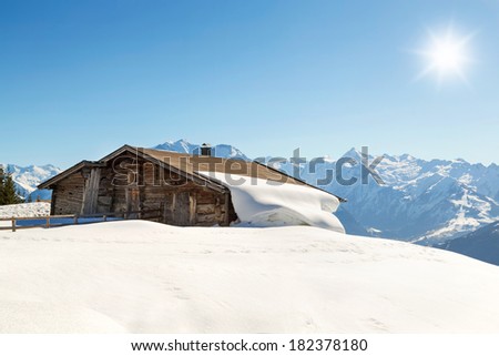 Mountain cabin in winter landscape