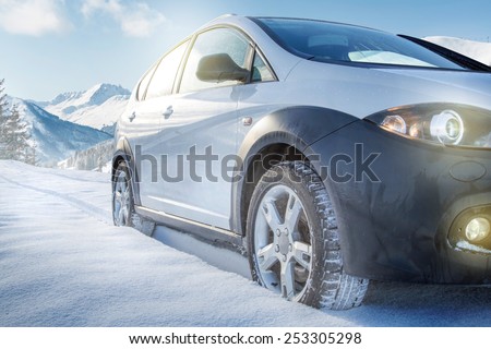 SUV car on snow covered mountain road