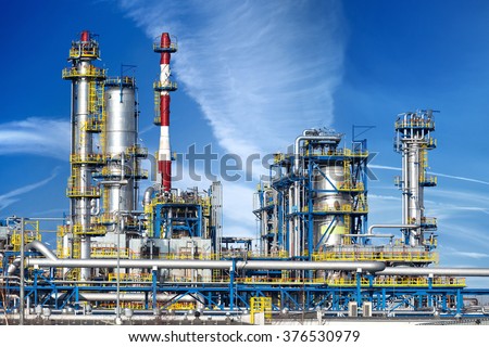 Petrochemical plant, oil refinery factory over blue sky.