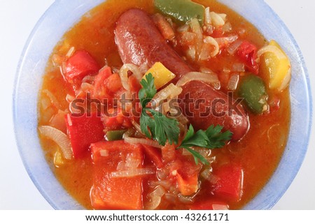 Sausage and boiled vegetables on a plate, isolated