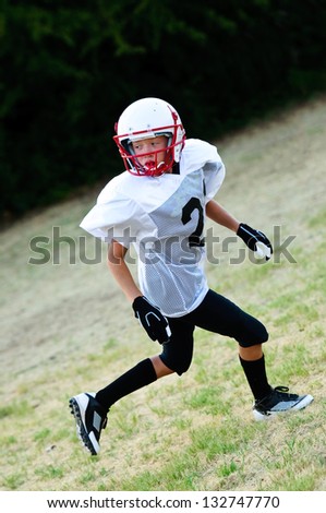 Youth football boy going out for a pass.