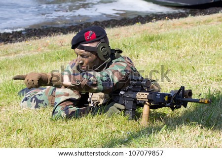 DEN HELDER, THE NETHERLANDS - JULY 7: A Dutch Marine giving directions during an amphibious assault demo during the Dutch Navy Days on July 7, 2012 in Den Helder, The Netherlands