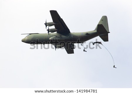 EDE, NETHERLANDS - SEP 22: RAF C-130 Hercules drops para troopers at the Operation Market Garden memorial on Sep 22, 2012 near Ede, Netherlands. Market Garden was a large Allied operation in 1944