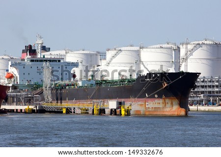 Antwerp, Belgium - July 9: Oil Tanker Near Oil Silos In The Port Of Antwerp July 9,2013 In Antwerp, Belgium. The Port Of Antwerp Is The Europe\'S Second Largest Sea Port After Rotterdam.