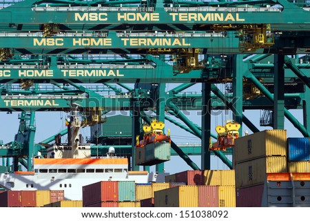 ANTWERP, BELGIUM - JULY 9: Container ship beaing unloaded at the MSC Home terminal July 9,2013 in Antwerp, Belgium. MSC Home terminal is the largest container terminal in the Port of Antwerp