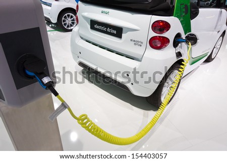 FRANKFURT, GERMANY - SEP 13: Charging a Smart Electric Drive at IAA motor show on Sep 13, 2013 in Frankfurt. More than 1.000 exhibitors from 35 countries are present at the world\'s largest motor show.