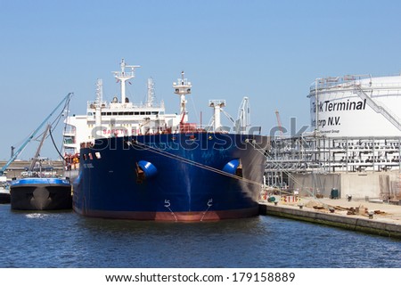 ANTWERP, BELGIUM - JULY 9: Oil tanker moored near an oil silo in Port of Antwerp July 9,2013 in Antwerp, Belgium. The Port of Antwerp is the Europe\'s second largest sea port after Rotterdam.