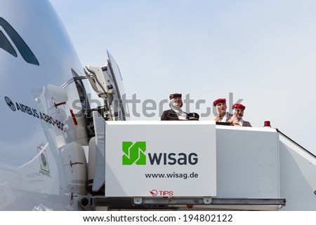 BERLIN, GERMANY - MAY 21: Emirates Airline Airbus A380 flight attendants  are watching the airshow of at the International Aerospace Exhibition ILA on May 21st, 2014 in Berlin, Germany.