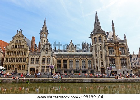 GENT - JUN 18: Tourists and students in the historical center of Gent with it\'s gabled houses along the canal in Gent June 18, 2013 in Gent, Belgium