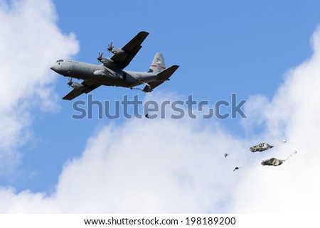 EDE, NETHERLANDS - SEP 22: US ANG C-130 Hercules drops para troopers at the Operation Market Garden memorial on Sep 22, 2012 near Ede, Netherlands. Market Garden was a large Allied operation in 1944