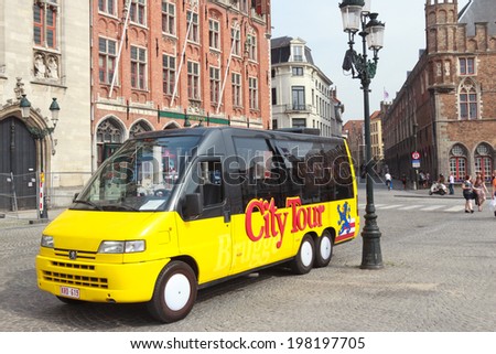 BRUGES, BELGIUM - JUNE 18: City tour sightseeing bus on the mail square in Bruges, Belgium on June 18, 2013. The historic city centre of Bruges is a prominent World Heritage Site of UNESCO