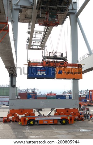 ROTTERDAM - SEP 8: Gantry crane operator moves containers on Sep 8, 2013 in Rotterdam, Netherlands. The port is the Europ\'s largest and facilitate the needs of a hinterland with 40,000,000 consumers.