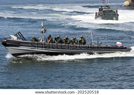 DEN HELDER, THE NETHERLANDS - JULY 7: Dutch Swat team in a speedboat during an assault demo at the Dutch Navy Days on July 7, 2012 in Den Helder, The Netherlands
