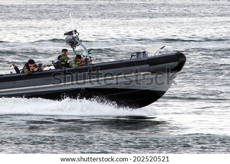 DEN HELDER, THE NETHERLANDS - JULY 7: Dutch Marines in a speedboat during an assault demo at the Dutch Navy Days on July 7, 2012 in Den Helder, The Netherlands