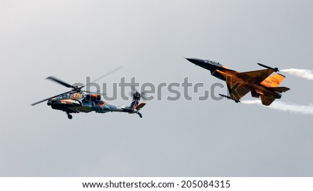 VOLKEL, THE NETHERLANDS - JUNE 15: Dutch demo F-16 and Apache helicopter perform at the Dutch Air Force Open Day on June 15, 2013 in Volkel, The Netherlands