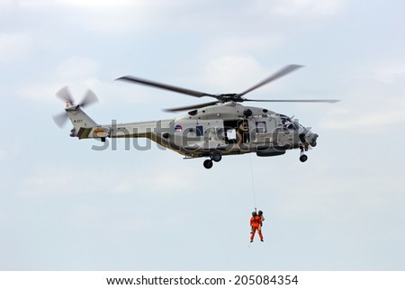 GILZE RIJEN, THE NETHERLANDS - JUNE 21:  Demonstration of a rescue operation by a Dutch Navy NH90 helicopter during  the Dutch Air Force Open House. June 21, 2014 in Gilze-Rijen, The Netherlands