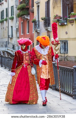 VENICE - FEB 6, 2013: Costumed couple during Venice Carnival. Carnival is an annual festival starting around two weeks before Ash Wednesday and ends on Shrove Tuesday or Mardi Gras