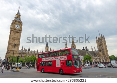LONDON - JUL 01, 2015: A Double-decker bus passing the Big Ben.