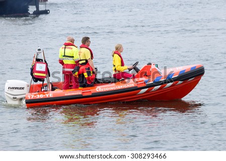 AMSTERDAM, THE NETHERLANDS - AUGUST 19, 2015: Rescue squad boat in the North Sea Canal during the pre-SAIL 2015 event.
