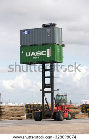 ROTTERDAM, NETHERLANDS - SEP 6, 2015: Mobile container handler in action at a container terminal in the Port of Rotterdam
