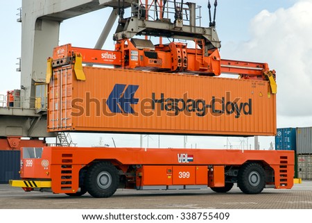 ROTTERDAM - SEP 6, 2015: Crane operator picking up a sea container in the Port of Rotterdam. The port is the Europ\'s largest and facilitate the needs of a hinterland with 40,000,000 consumers.