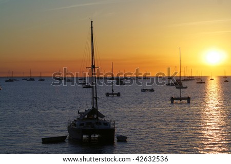 Boats resting at sunset over sea.