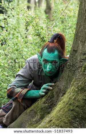 HAARZUILENS, THE NETHERLANDS - APRIL 25: Elf behind a tree at the Elf Fantasy Fair on April 25, 2010 in Haarzuilens, The Netherlands