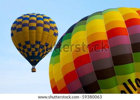 Multicoloured balloons taking off on a clear afternoon
