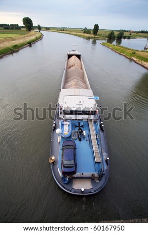 Cargo ship shipping gravel on the IJssel river in The Netherlands