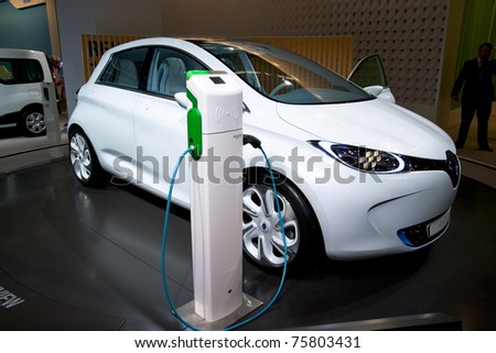 AMSTERDAM - APRIL 22 - Electric Renault Zoe concept car next to a charger pole, on display at the AutoRAI motorshow. April 22, 2011 in Amsterdam, The Netherlands.