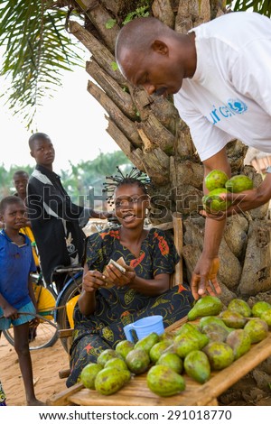 LUKONGA, DEMOCRATIC REPUBLIC OF CONGO - CIRCA, SEPTEMBER 2008. UNICEF mission against tetanus. Young african girl selling mango on the street.