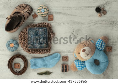 Its a Boy Baby Shower or Nursery layout with soap, booties, socks on pale white shabby chic table