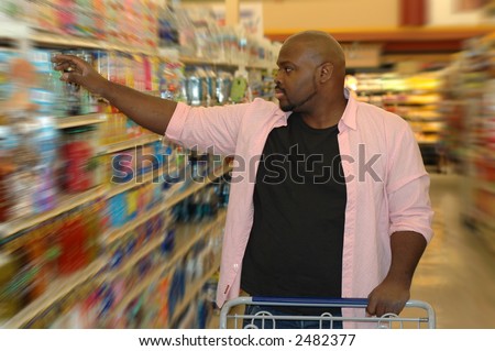 Shopping for groceries.  Picking an item off the shelf.
