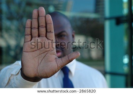 Man holding up his hand in a protest gesture
