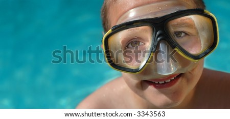 Boy in diving mask on a hot summer day; horizontal banner with plenty of space for copy
